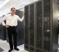 Woodside Energy Ridsdill-Smith next to supercomputer 300x