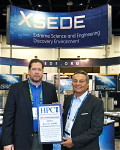 Tom Tabor presenting the award to the NSF XSEDE's PI John Towns