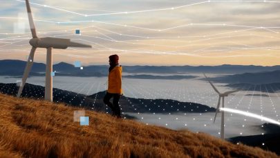 Woman walking up hill with turbine and valley below. Grid added to show networking. Intel branding overlay added. Source: Intel